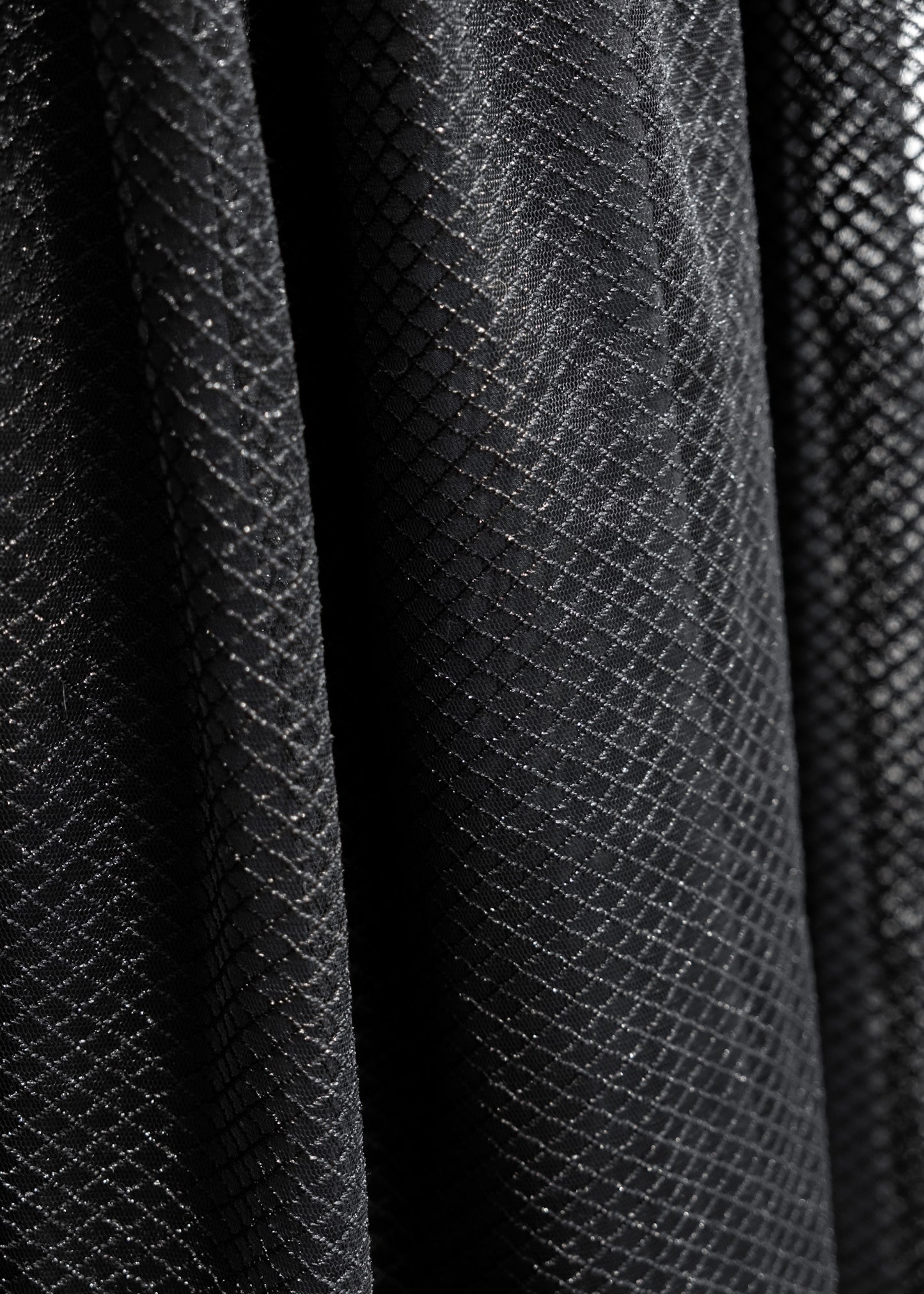 Close-up of black diamond-patterned tulle dress