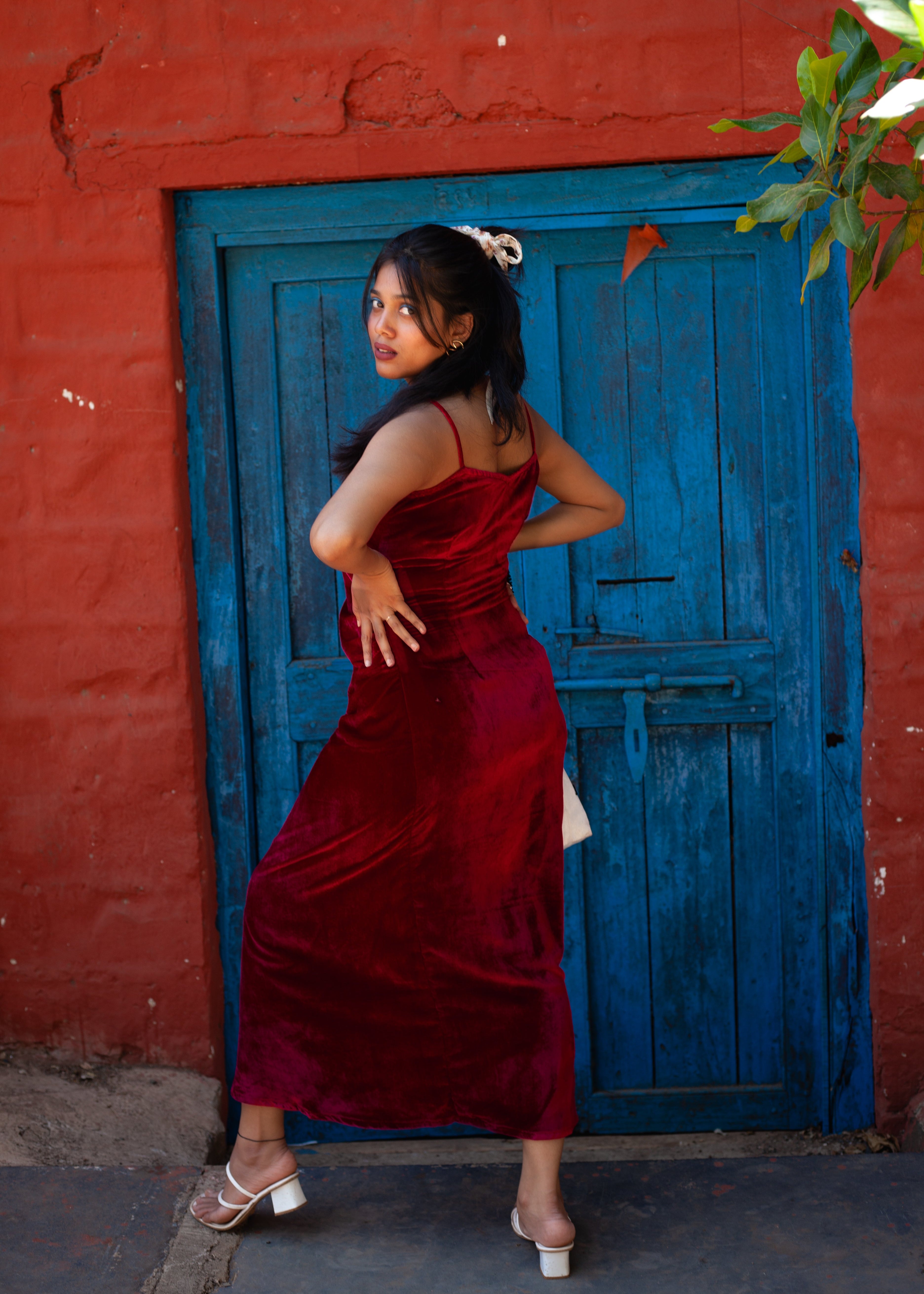 Back view of Deep Red velvet Berry Blush slip dress with V neckline, spaghetti straps, and side gathered detail.