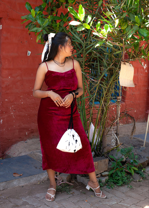 Deep Red velvet Berry Blush slip dress with V neckline, spaghetti straps, and side gathered detail styled for a party look.