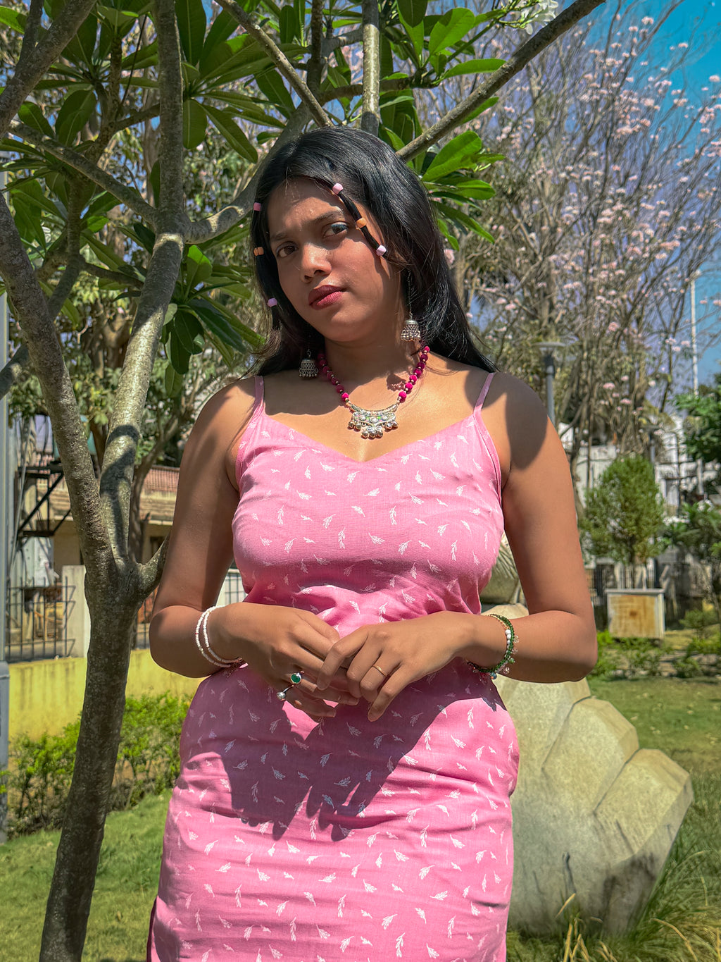 Close-up of Cotton Candy Slip dress featuring V neckline and spaghetti straps styled with oxidized jewellery from Tales Summer collection.