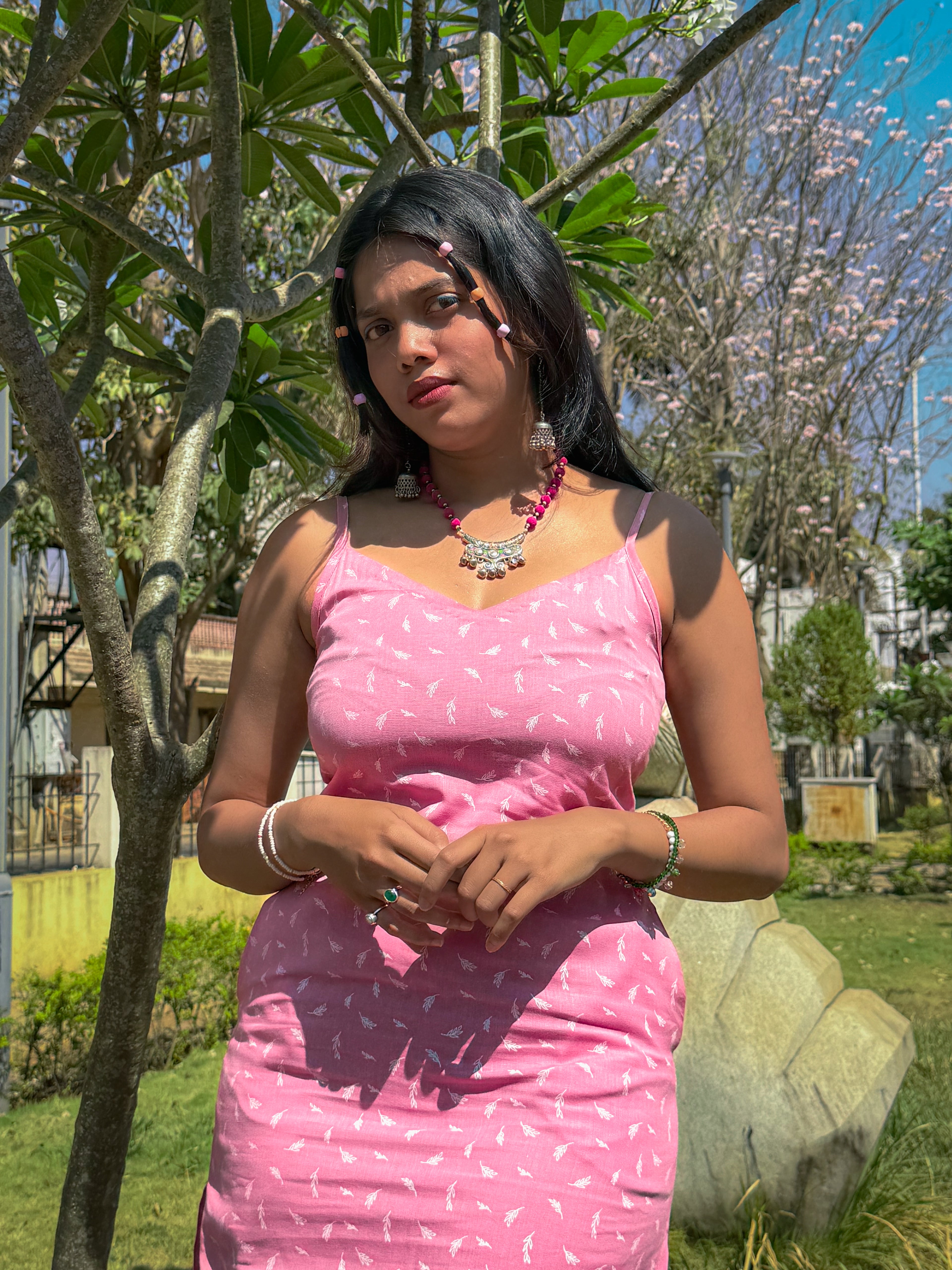 Close-up of Cotton Candy Slip dress featuring V neckline and spaghetti straps styled with oxidized jewellery from Tales Summer collection.
