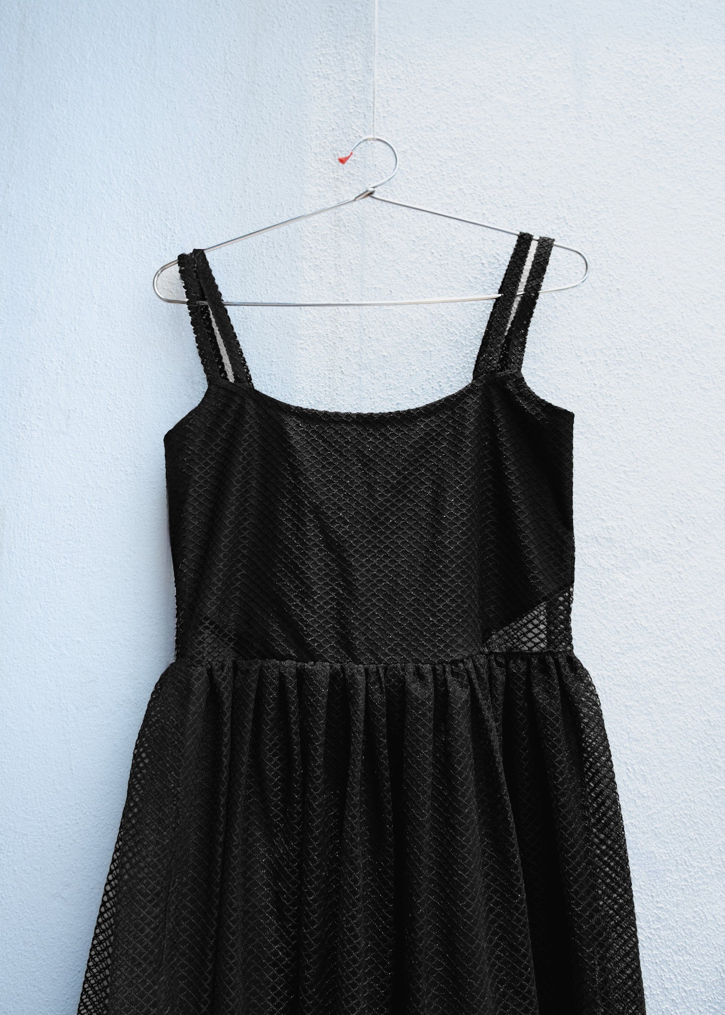 Black tulle dress with straight neckline, thin straps and sheer side waist cut-out.