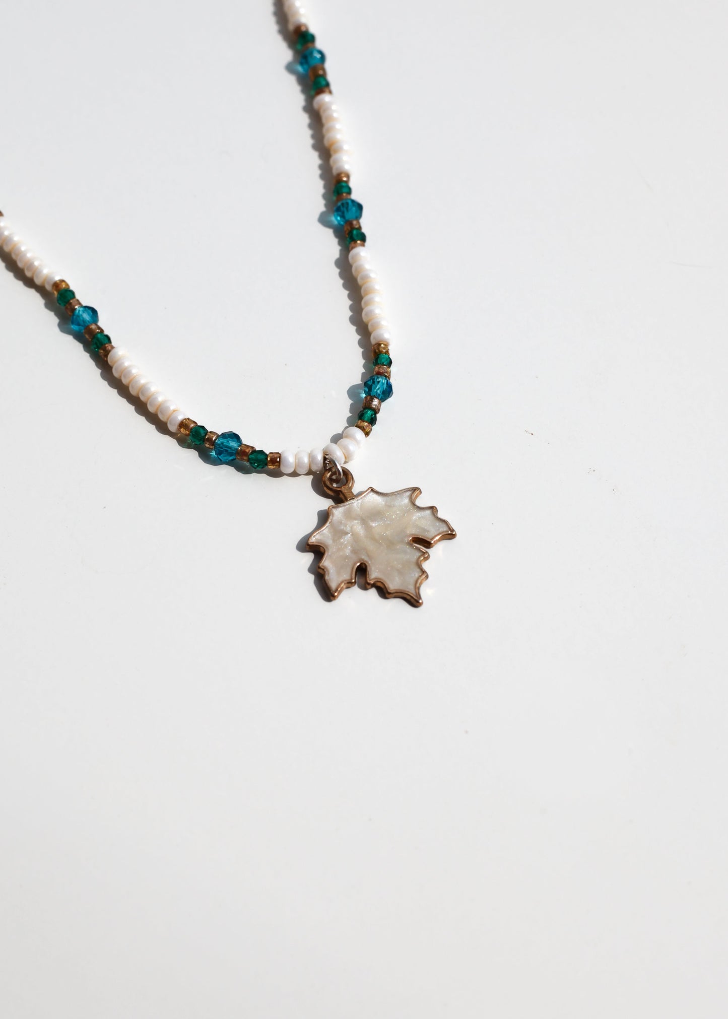 Necklace with autumn leaf pendant on a white background