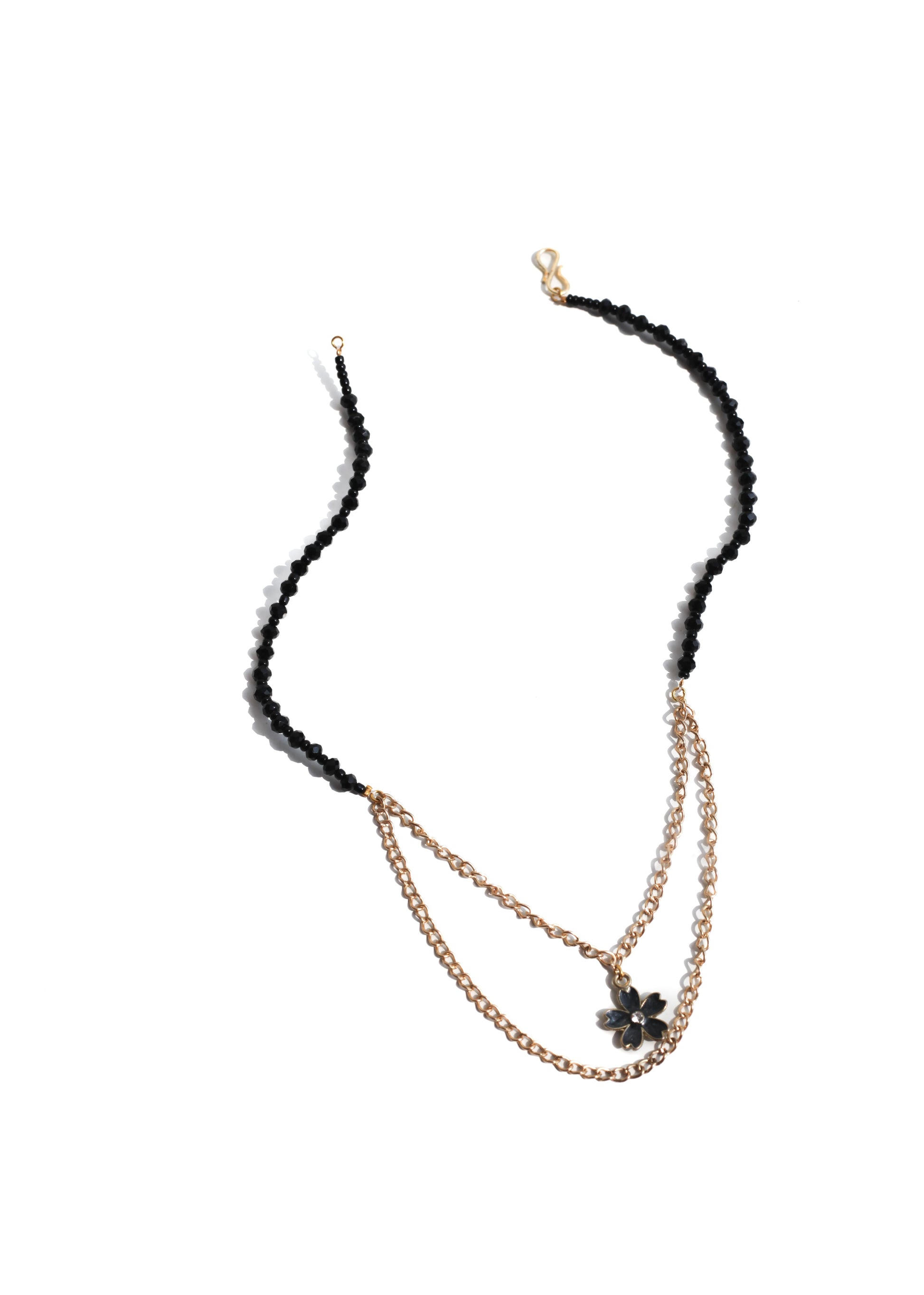 Necklace with black and gold chain on a white background