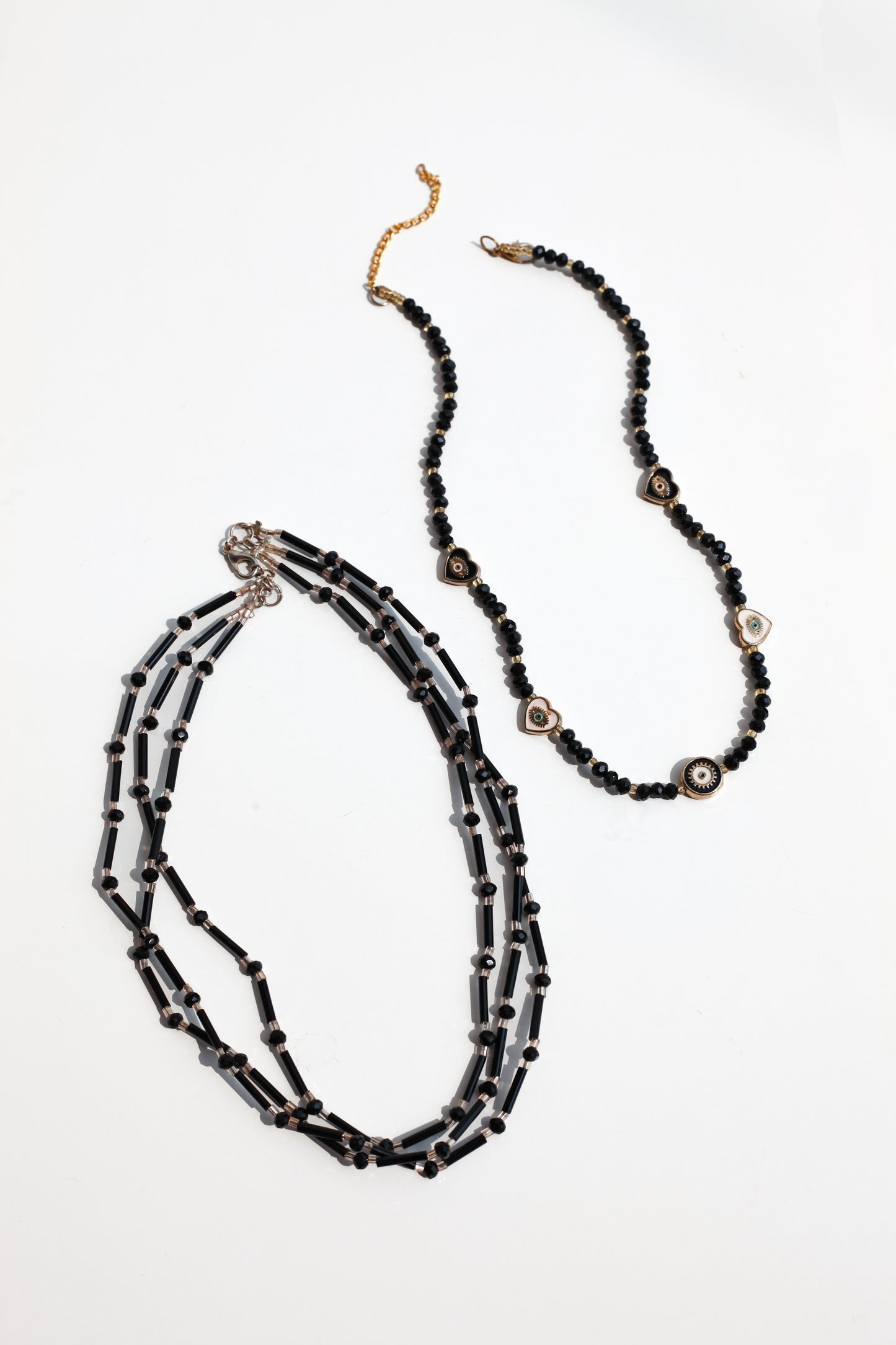 Black beaded necklace on a white background