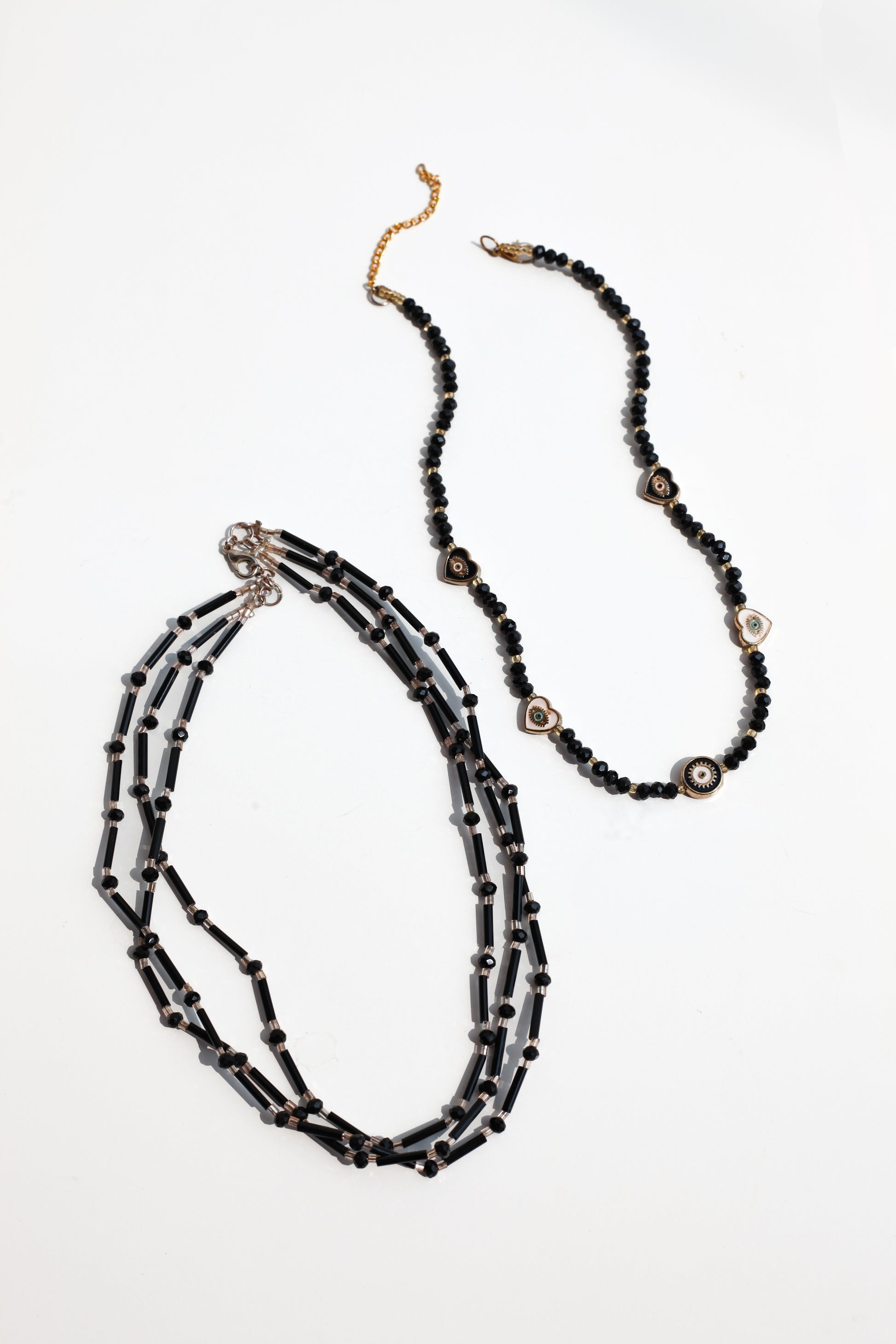 Black beaded necklace on a white background
