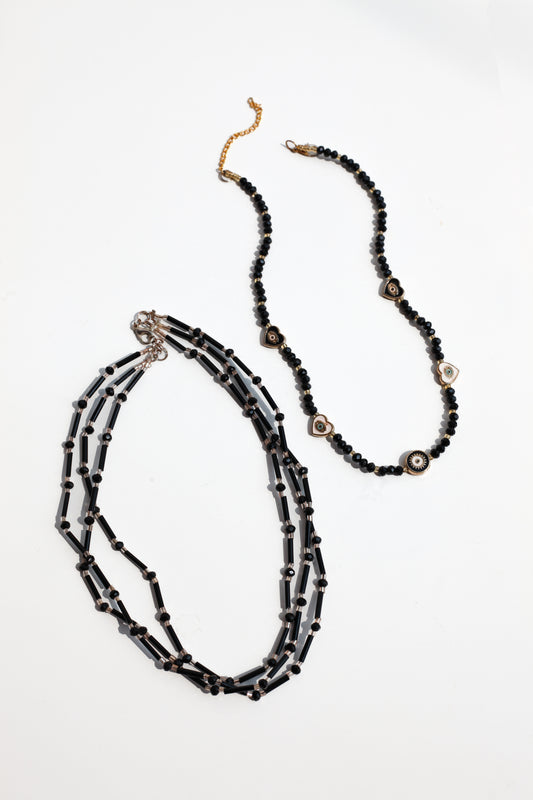 Black beaded necklace on a white background
