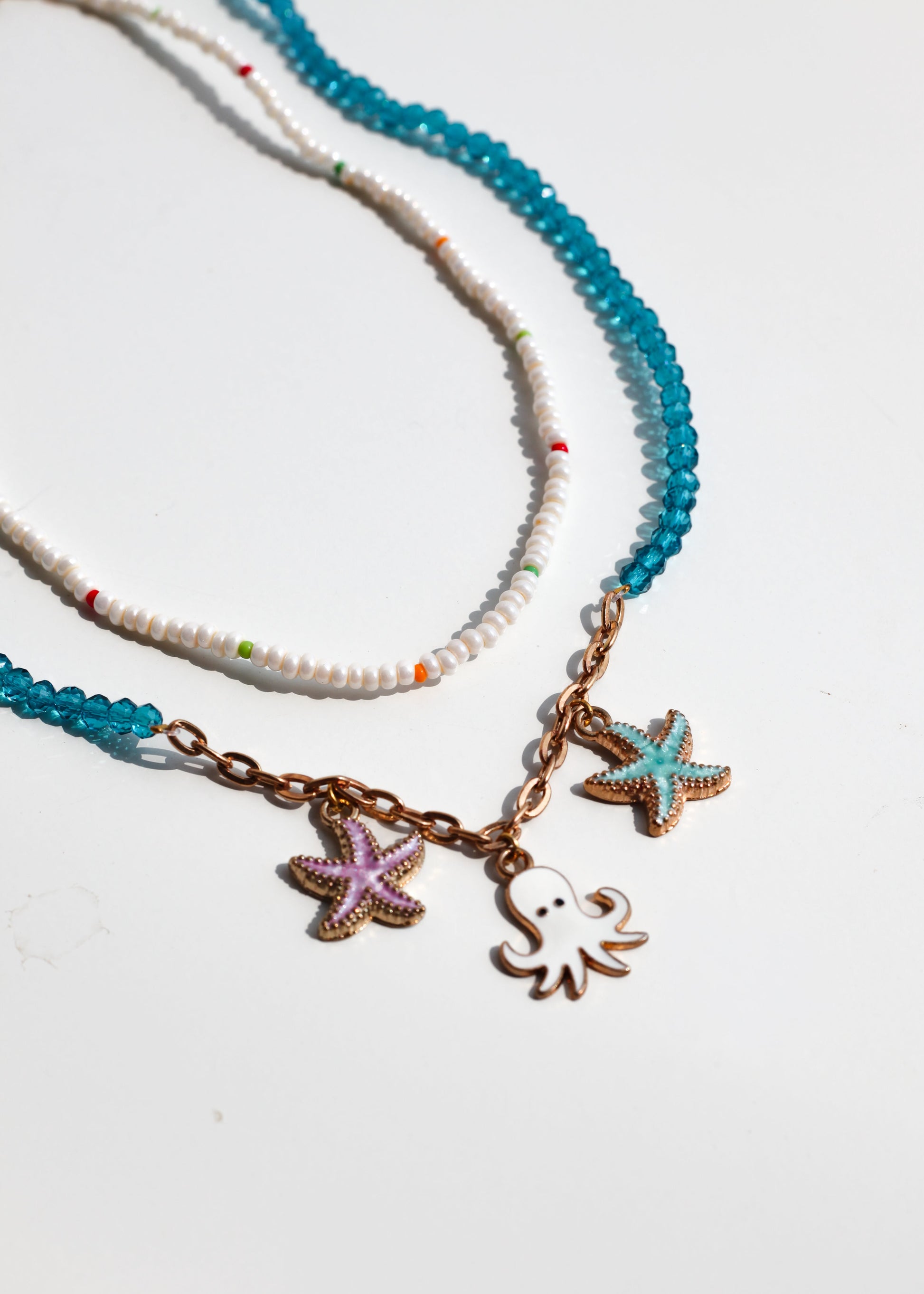 Necklace with starfish and octopus charms on a white background