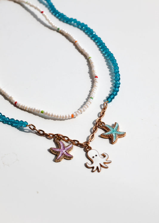 Necklace with starfish and octopus charms on a white background