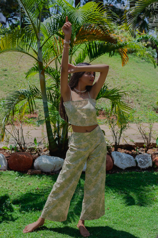 Sage Green printed poplin Pista Swirl Set featuring asymmetrical crop top with square neckline and spaghetti straps, paired with matching flared trousers styled for a chic look.