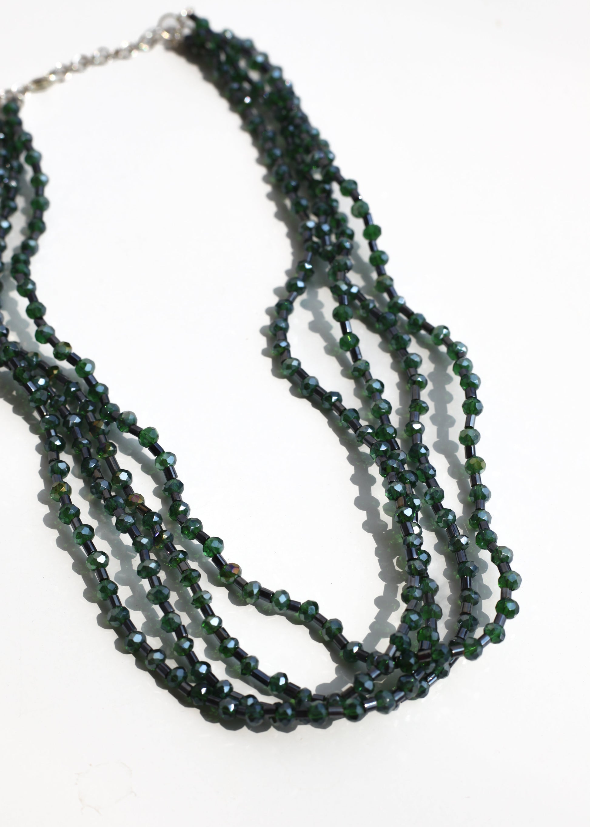 Multistrand beaded necklace on a white background