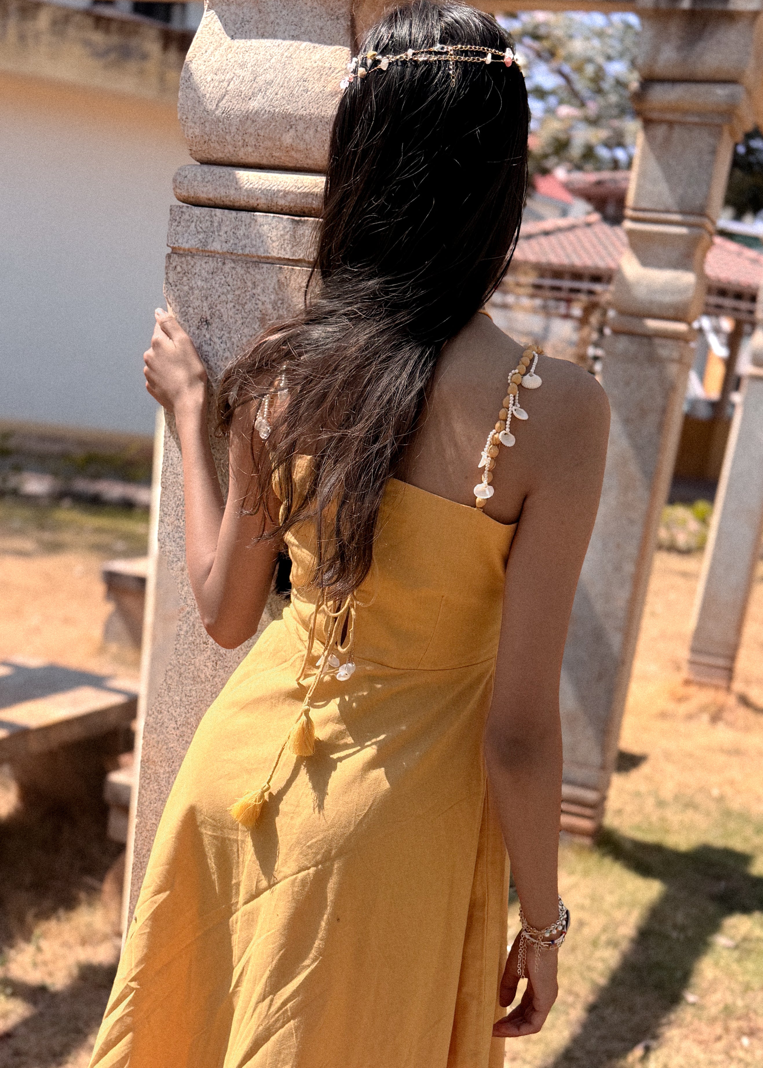 Close-up of the back detailing on the straps and tie-up closure of the Sandshells Circular Midi Dress.