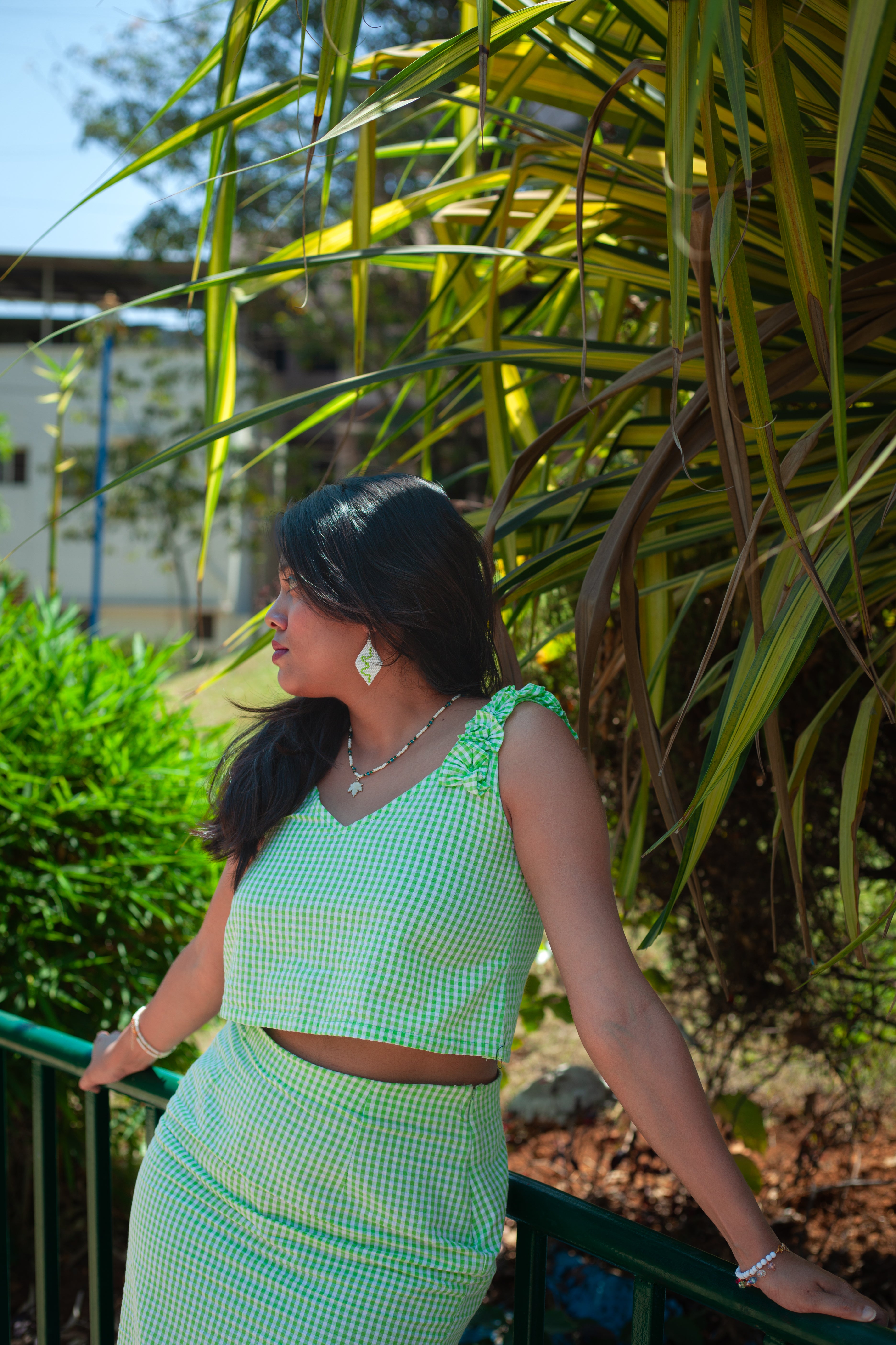 Close-up of the green and white seersucker of the Summer Sprite crop top showing cropped length styled with matching pencil skirt.