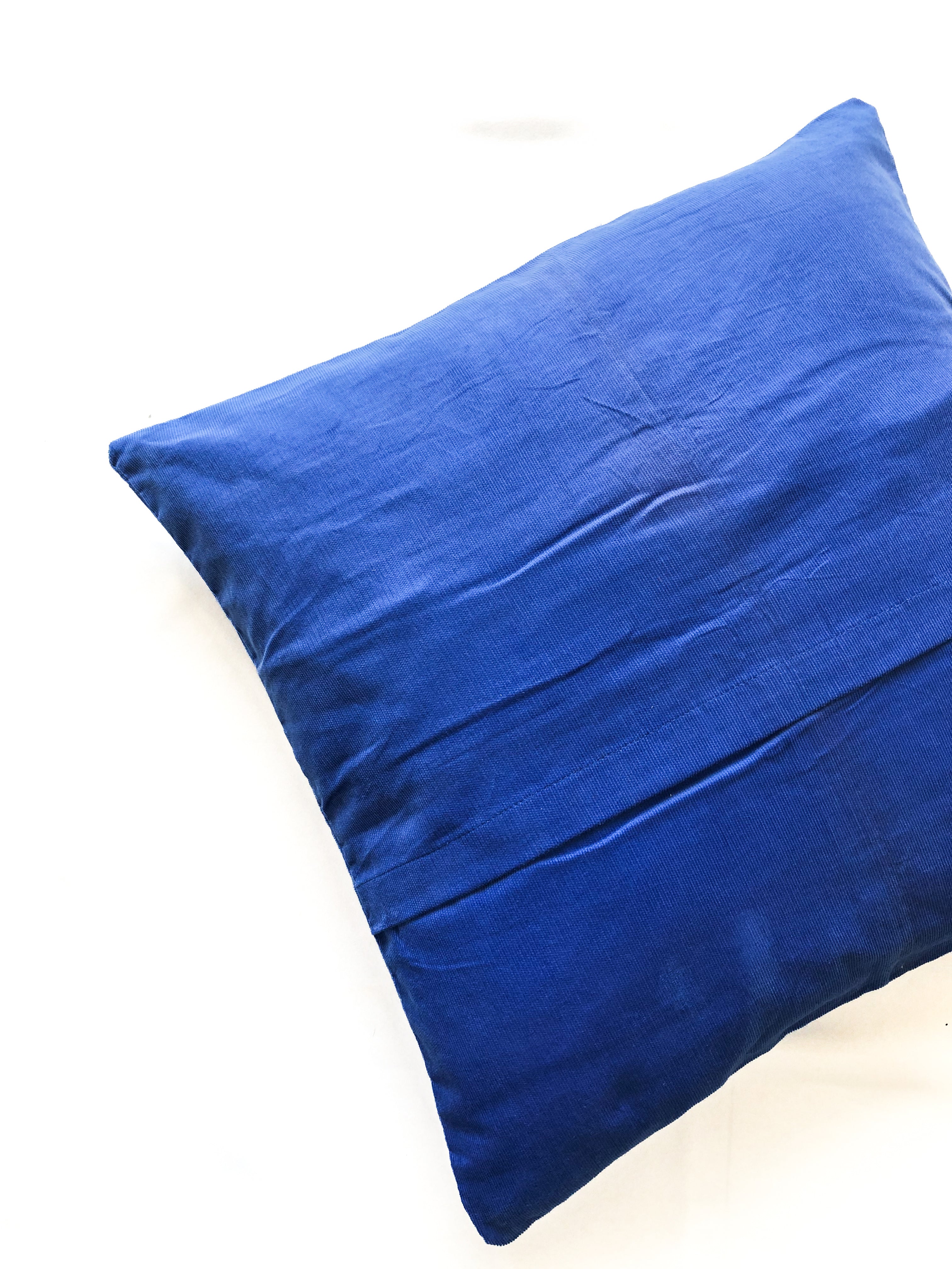 Back Close-up detail of cobalt blue cotton cushion cover, inspired by ocean waves. This modern, handcrafted cushion is perfect for coastal, boho, or minimalist home décor. Ideal for sofas, beds, and lounge spaces, adding a stylish and elegant touch.