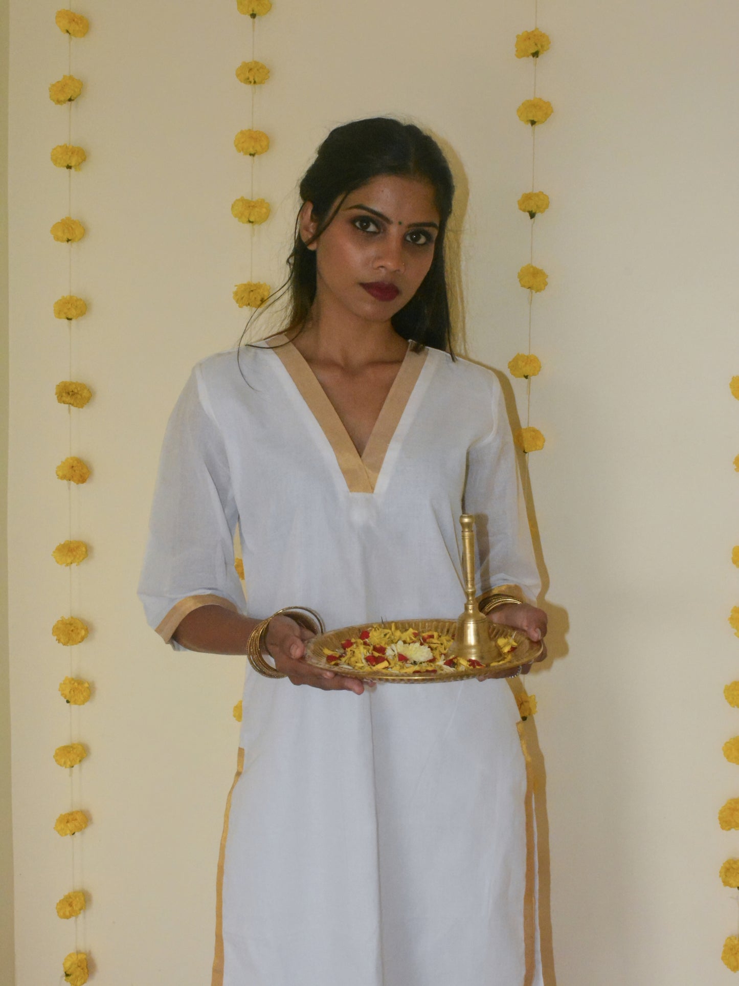 Pure white cotton Ila kurta with V neckline, and three quarter sleeves.