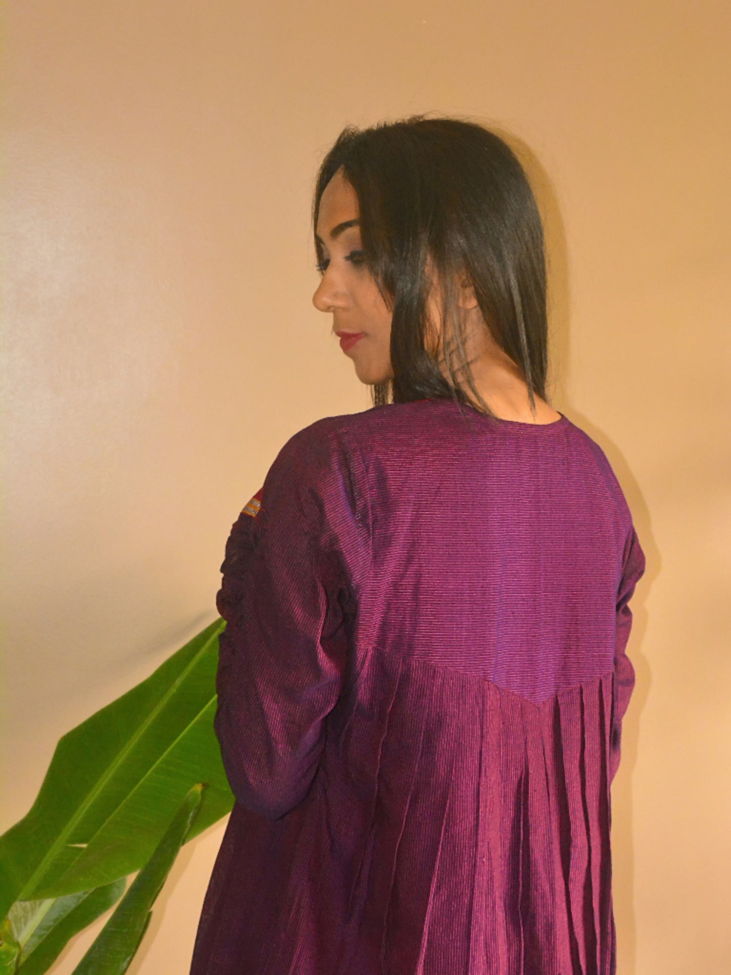 Back view of the purple cotton stripe Jamini Tunic, showing the pleats detail.