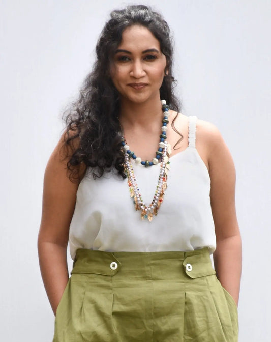 Model wearing off-white cami top paired with High-rise cotton-linen shorts from Resort 22 Collection