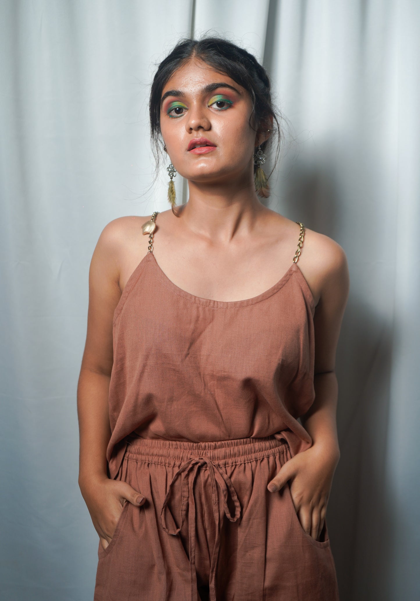 Brown Cotton-Linen Camisole top with round neckline, chain straps with golden metal shell embellishment.