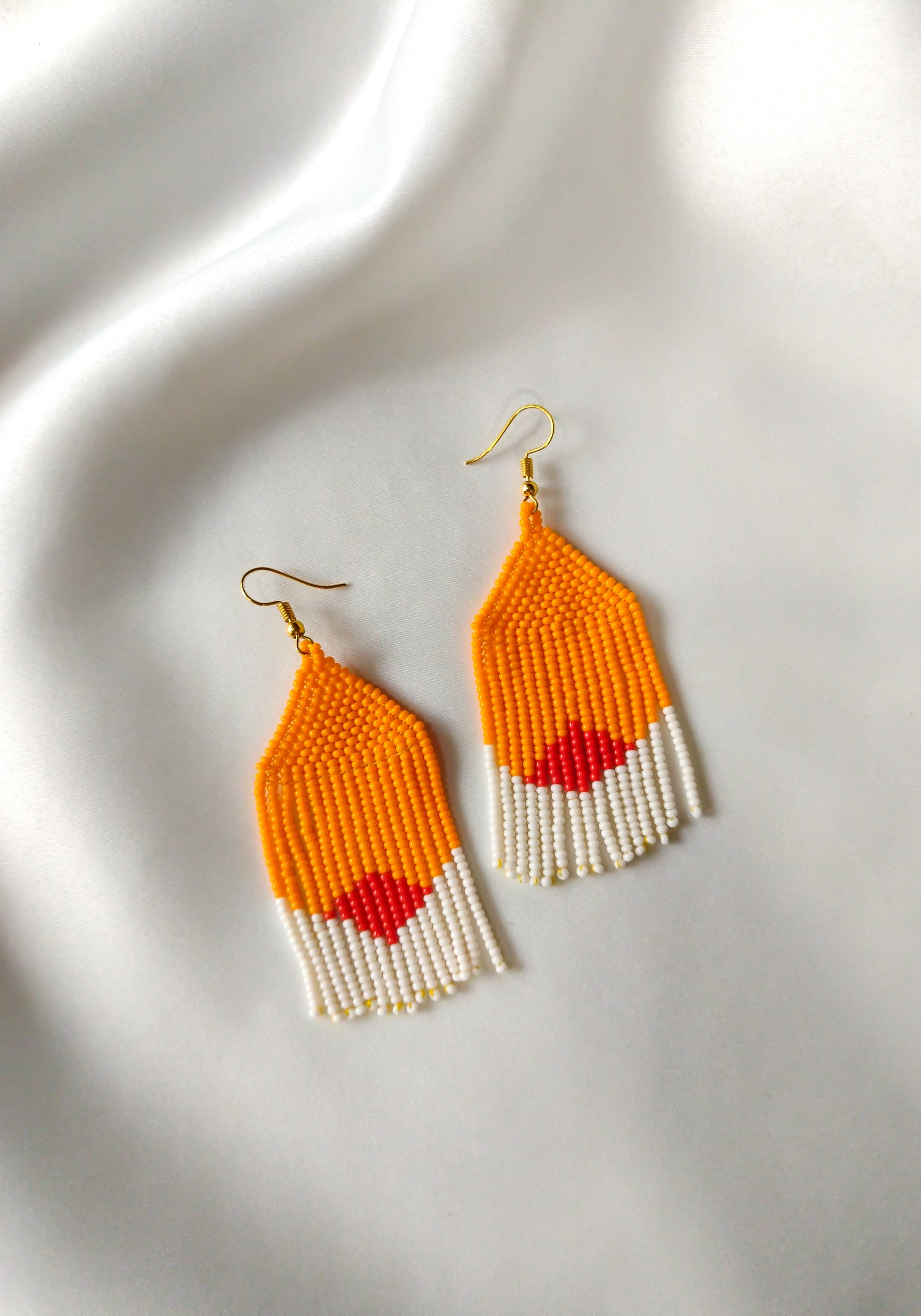 Zephyr earrings inspired by hibiscus on white background